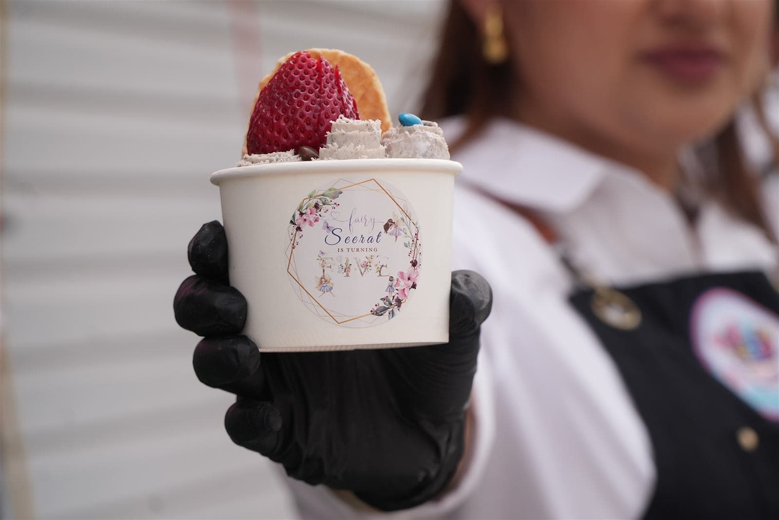 Custom-branded party cup topped with strawberry and a waffle chip