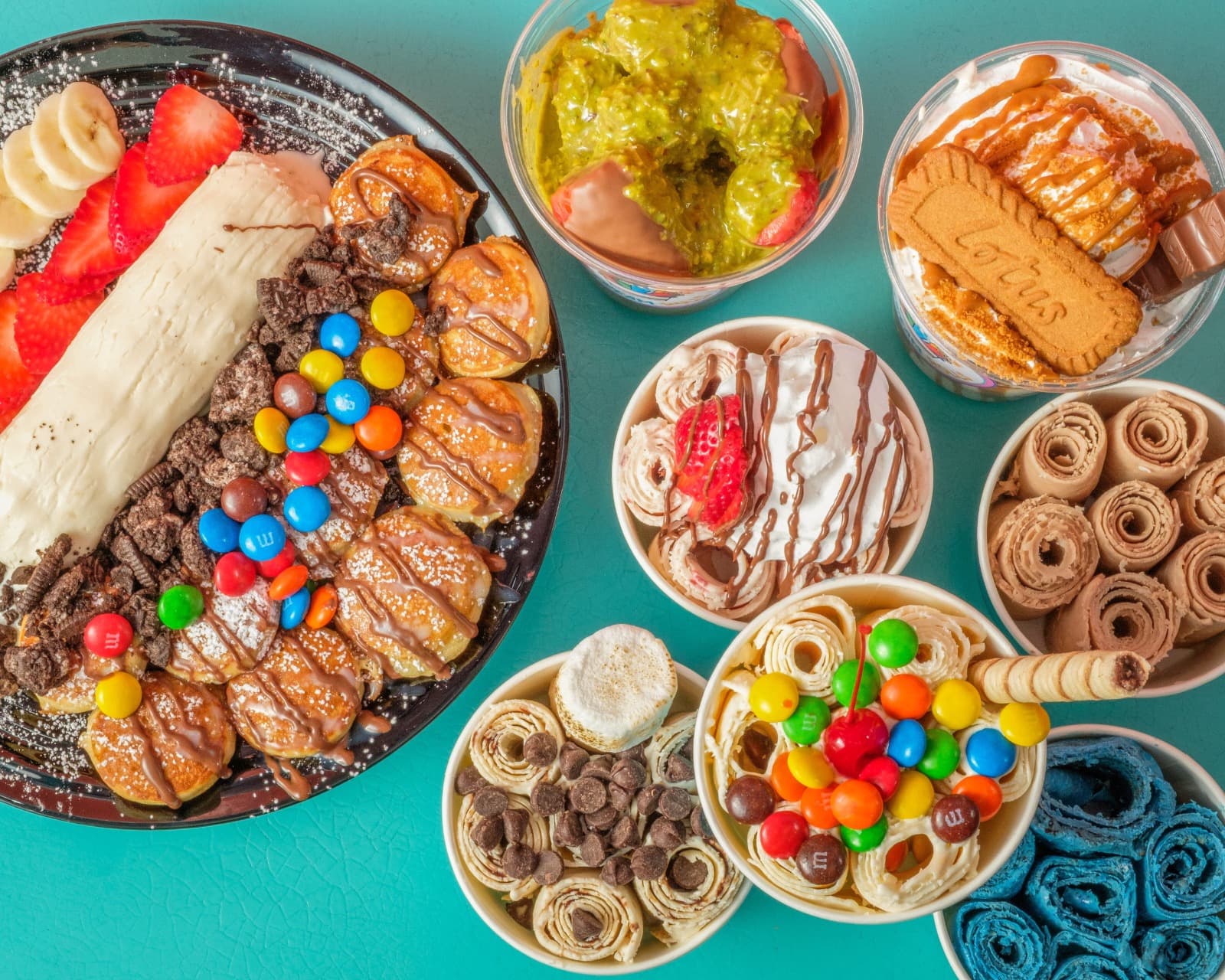 Assorted Rollitos ice cream rolls, cups, and toppings