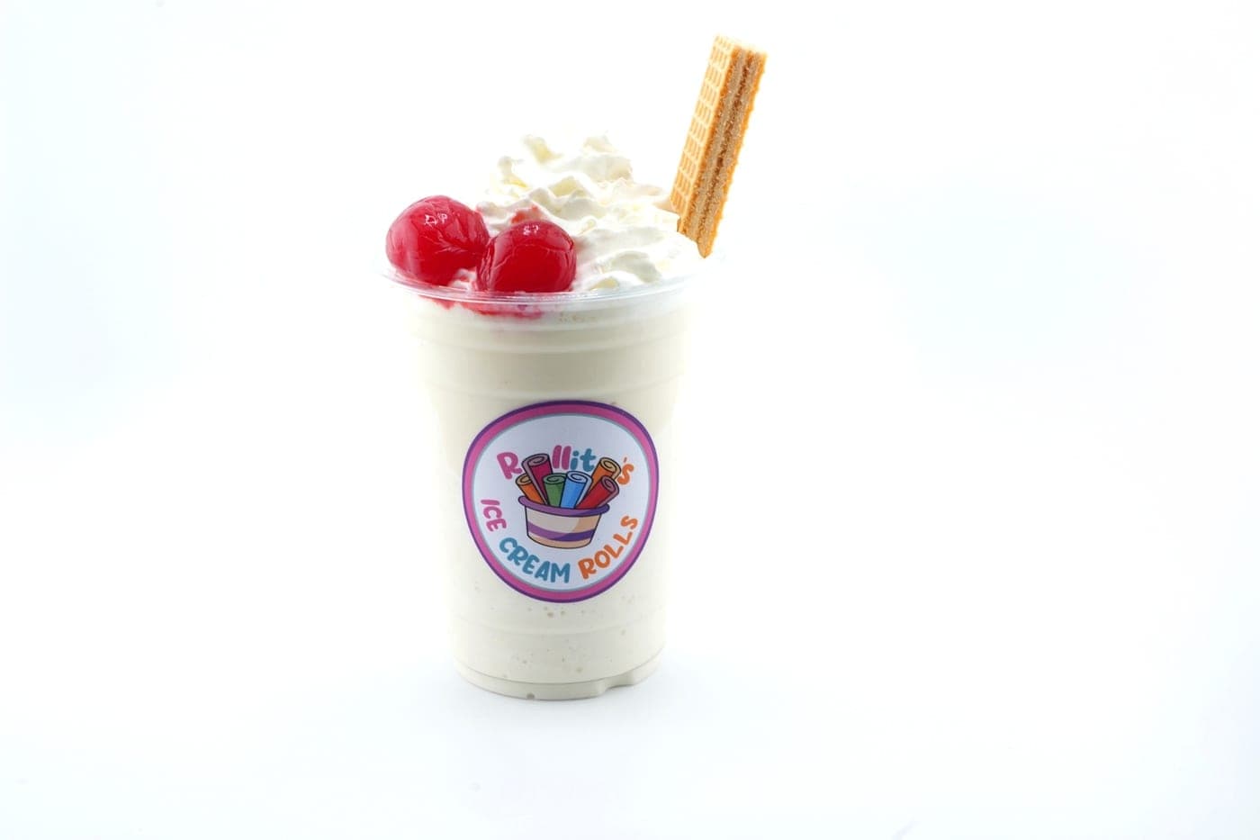 Vanilla milkshake topped with whipped cream, cherries, and a wafer